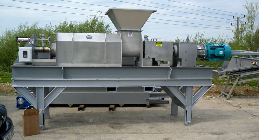 Industrial screw press with feed hopper on a steel frame