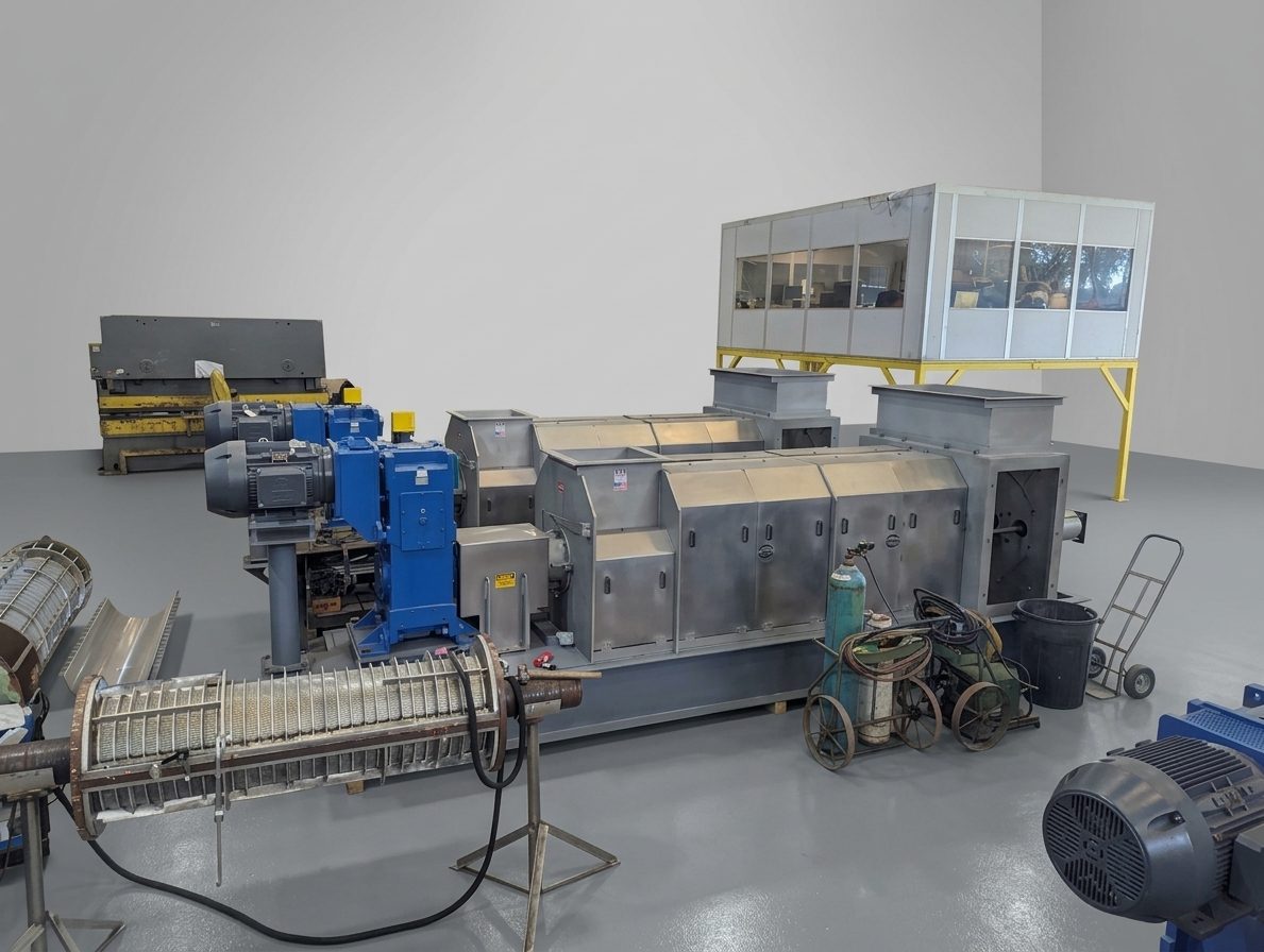 Stationary screw press line inside a processing facility